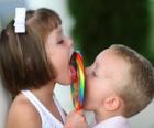 Ένα κορίτσι και ένα αγόρι πιπίλισμα ένα μεγάλο lollipop